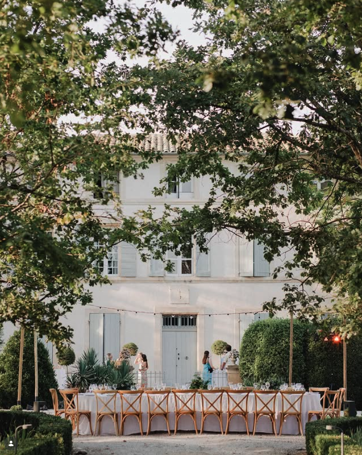 The bastide at dusk with a long table set in the garden