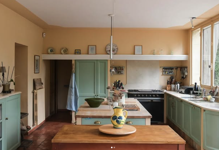 The butter-yellow kitchen with sage cabinets